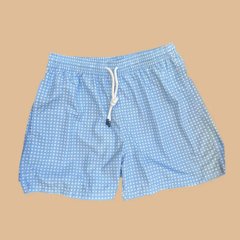 Maillot de bain bleu motif fleurs blanches